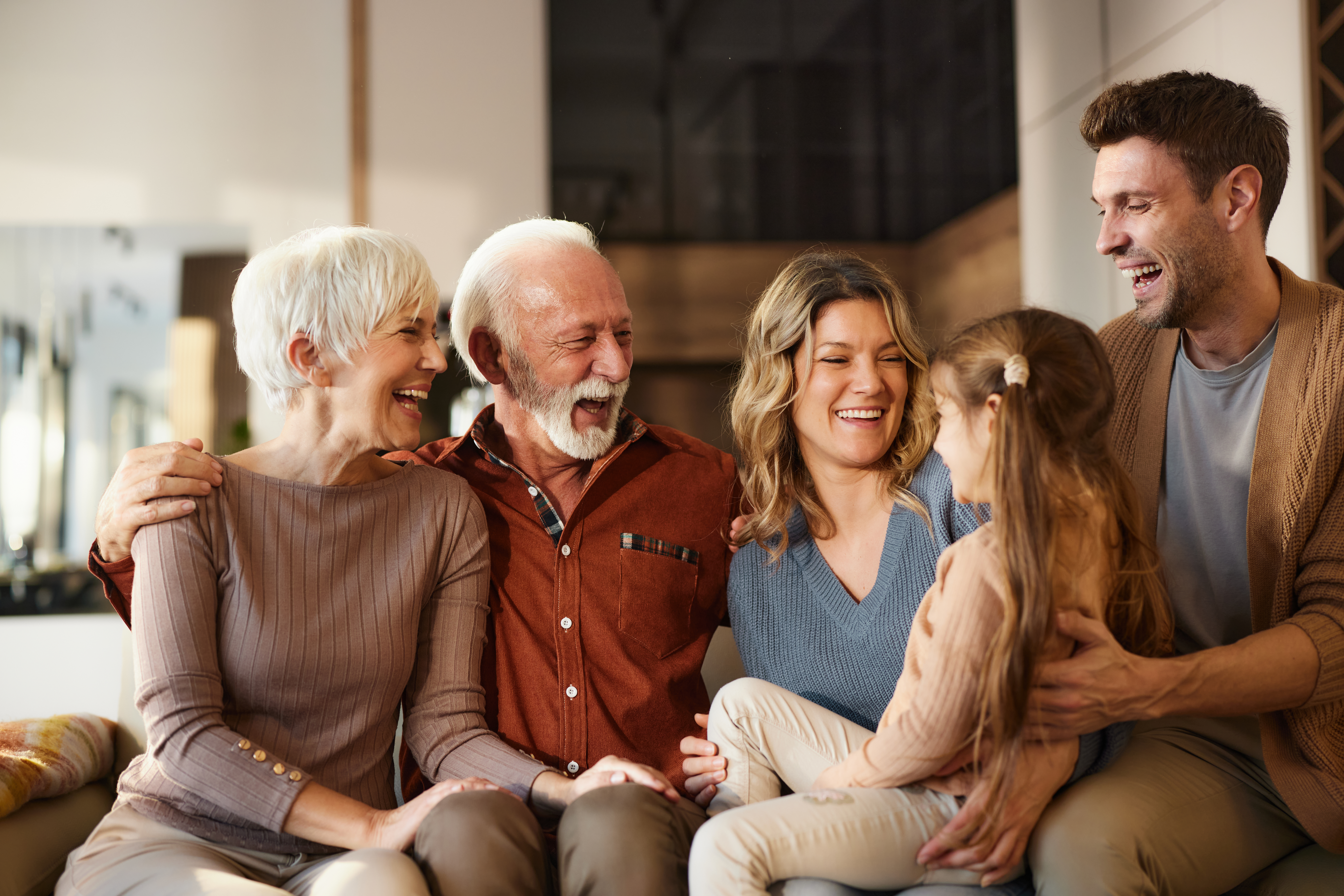 Multigenerational Family Sitting And Smiling