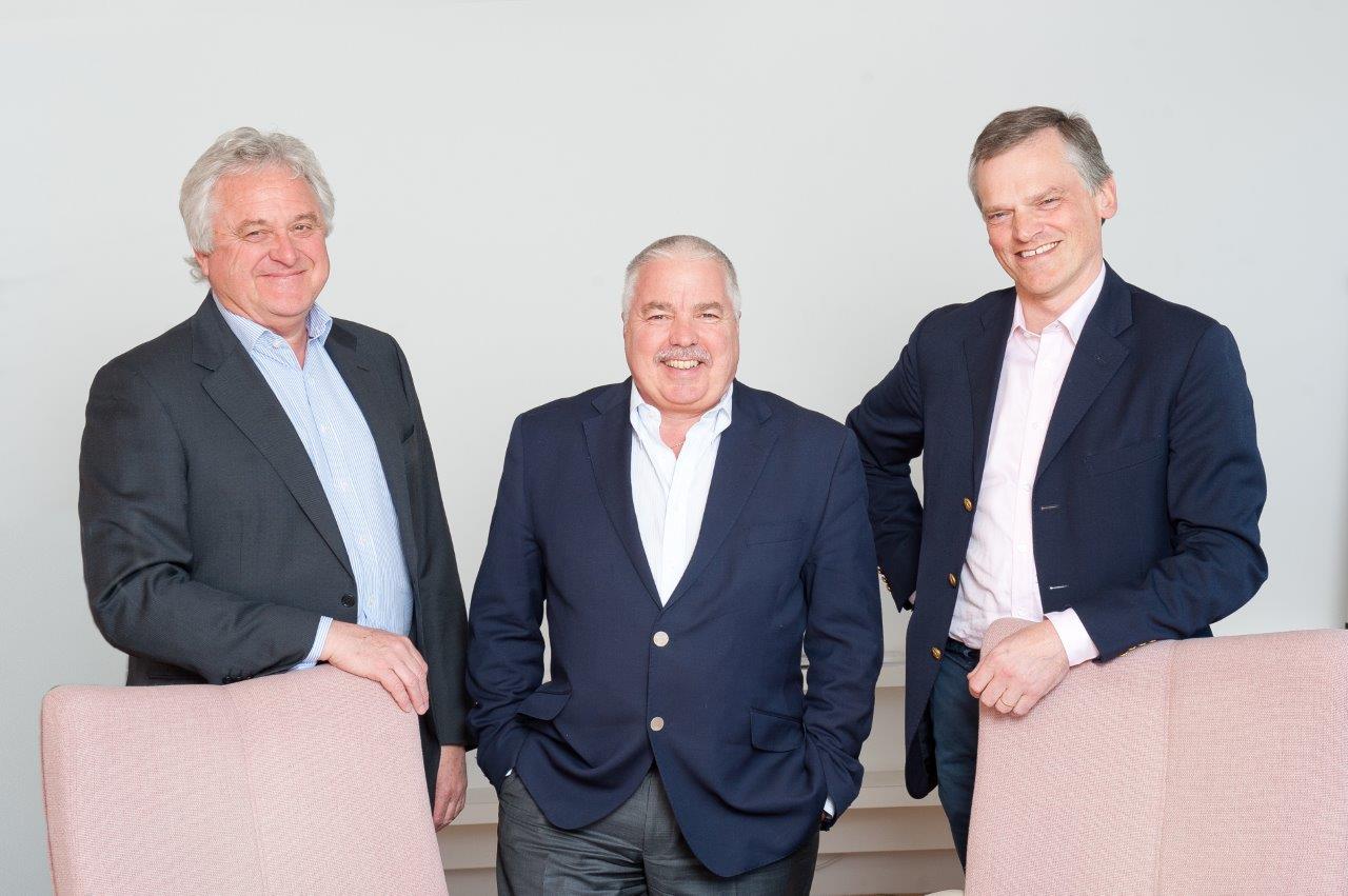 Brian Morris, Martyn Crespel and Simon Thornton posing for a professional photograph behind chairs.