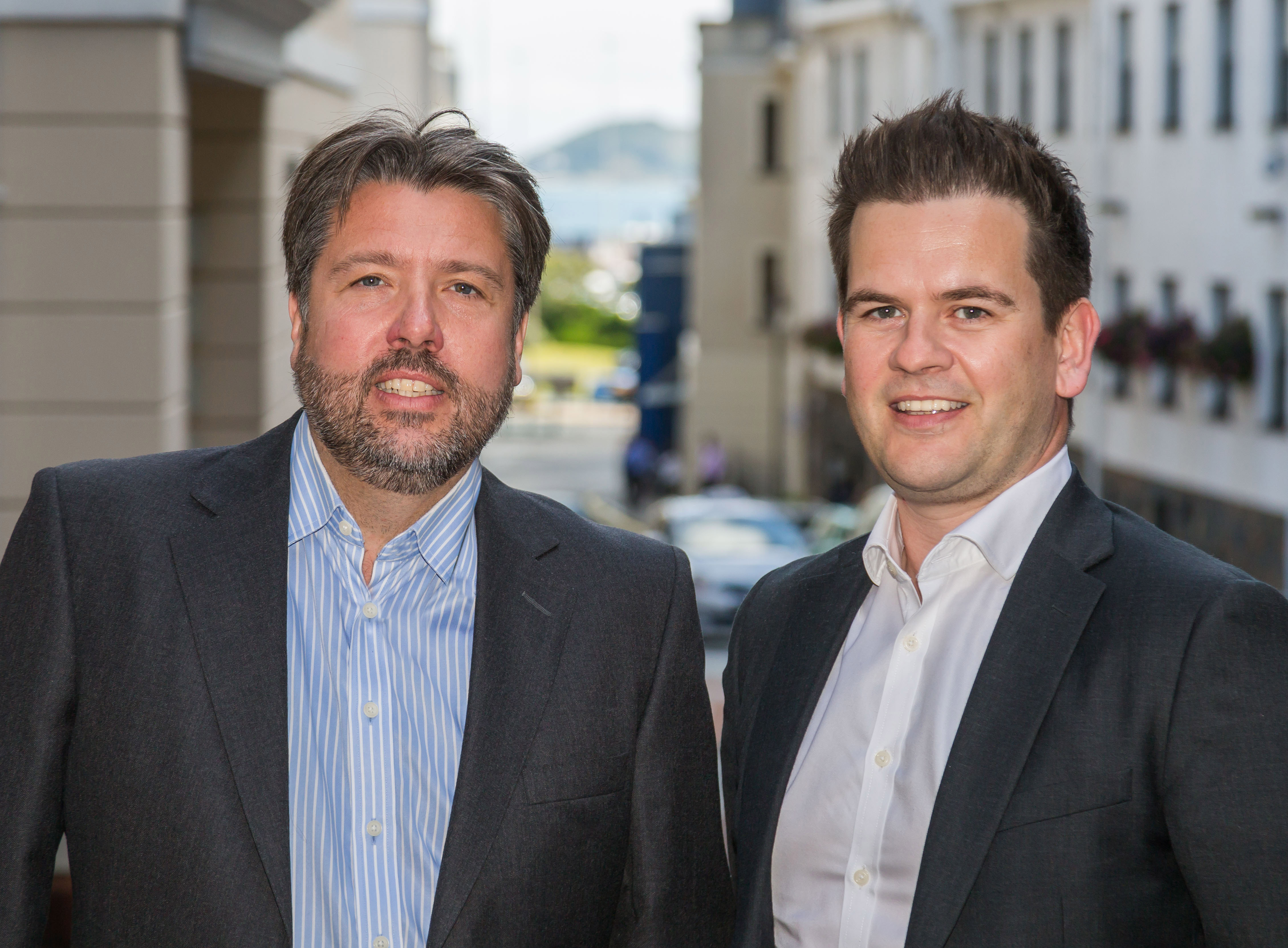  Rupert Pleasant and Paul Blackwell standing side by side outside the Guernsey Office